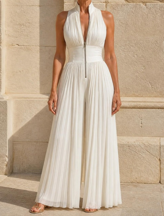 Linnea jumpsuit in White — full length against a sandstone wall