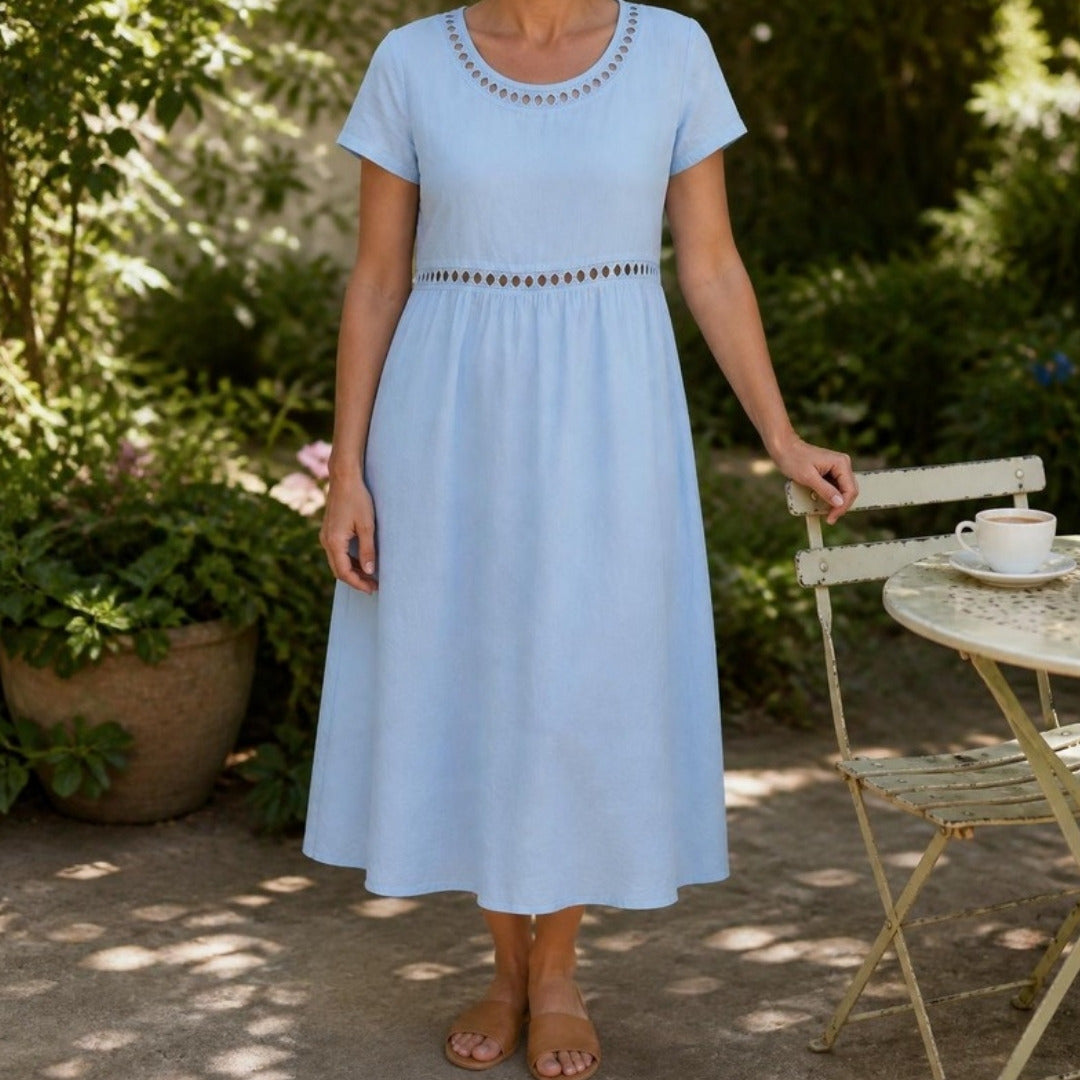 Rosemary midi dress in Light Blue worn in a garden courtyard