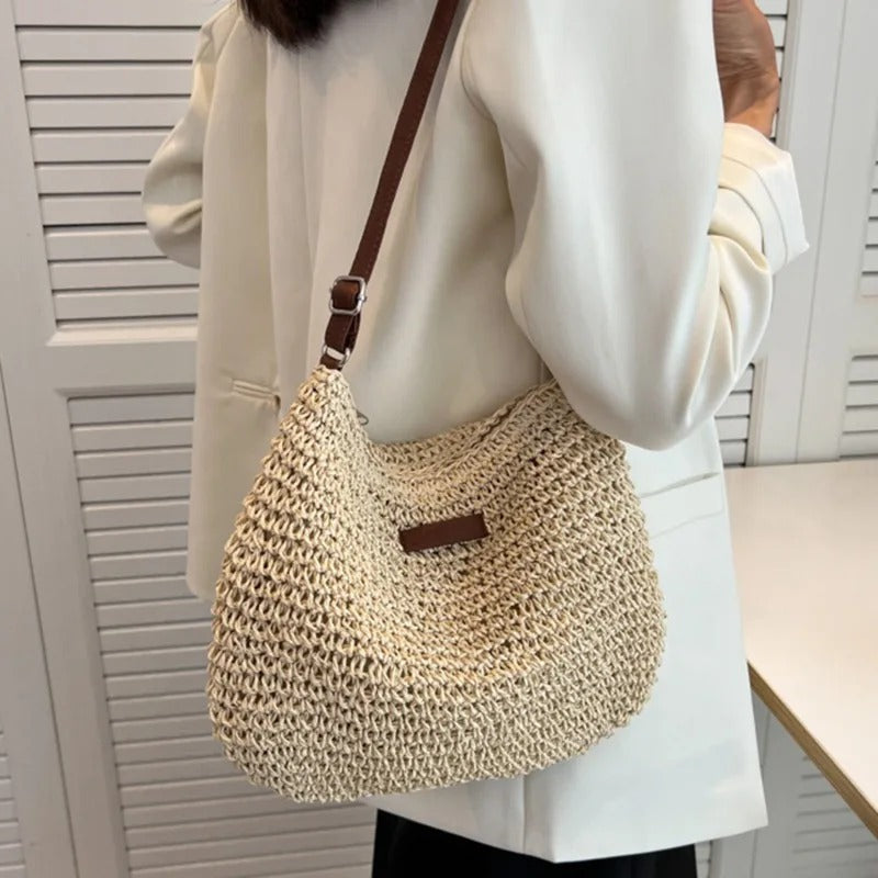 Petra woven crossbody bag in beige worn with a cream blazer
