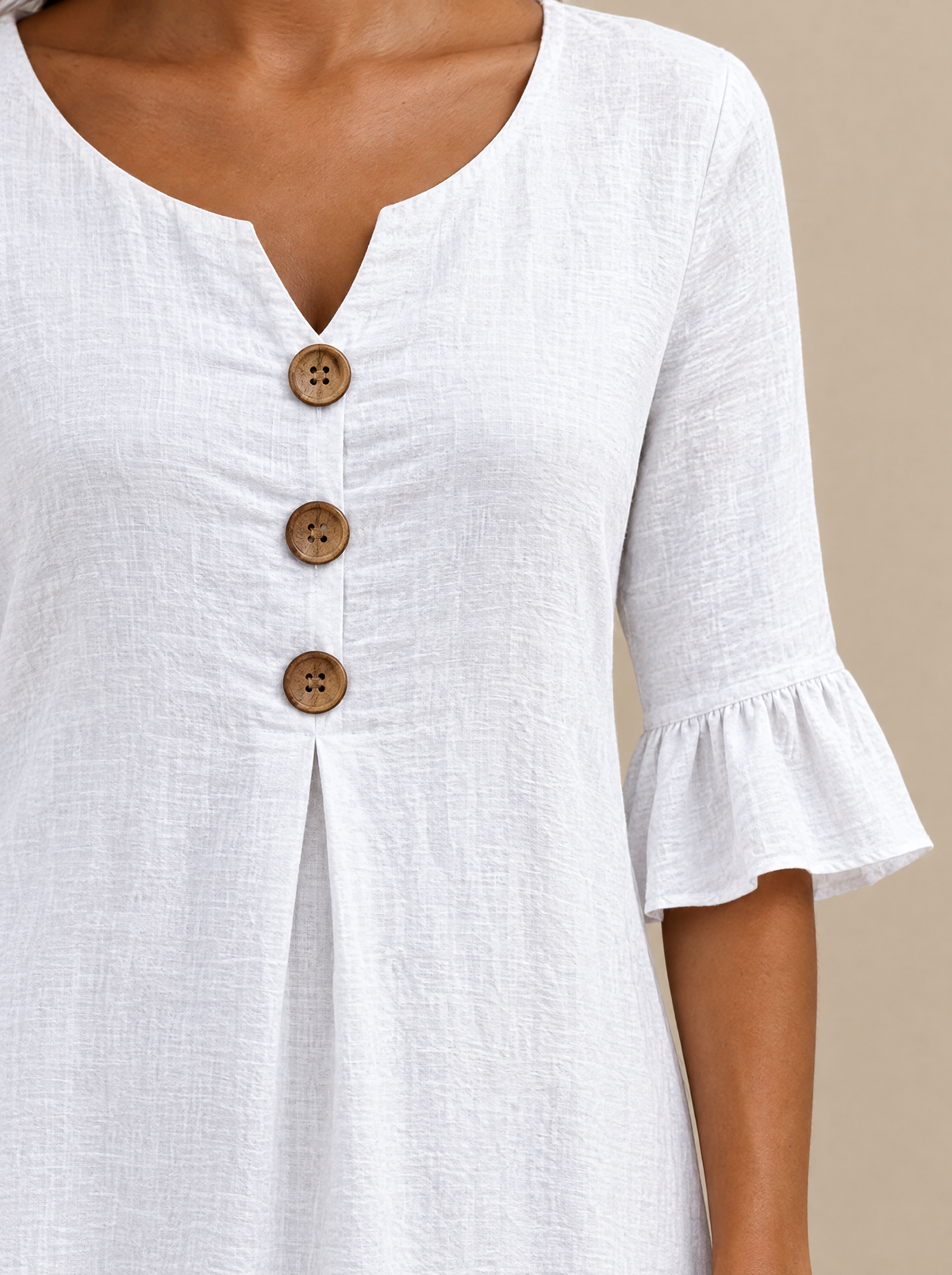 Naomi dress close-up of V-neck, buttons and ruffle sleeve