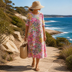 Primrose midi dress in Pink — worn on a coastal walk with sandals and a straw bag