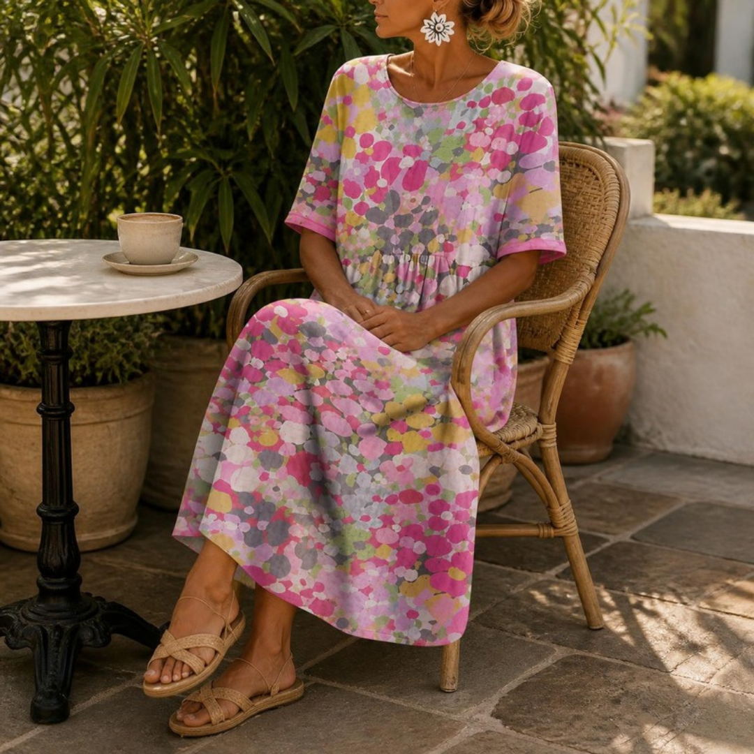 Primrose midi dress in Pink — seated at an outdoor café table