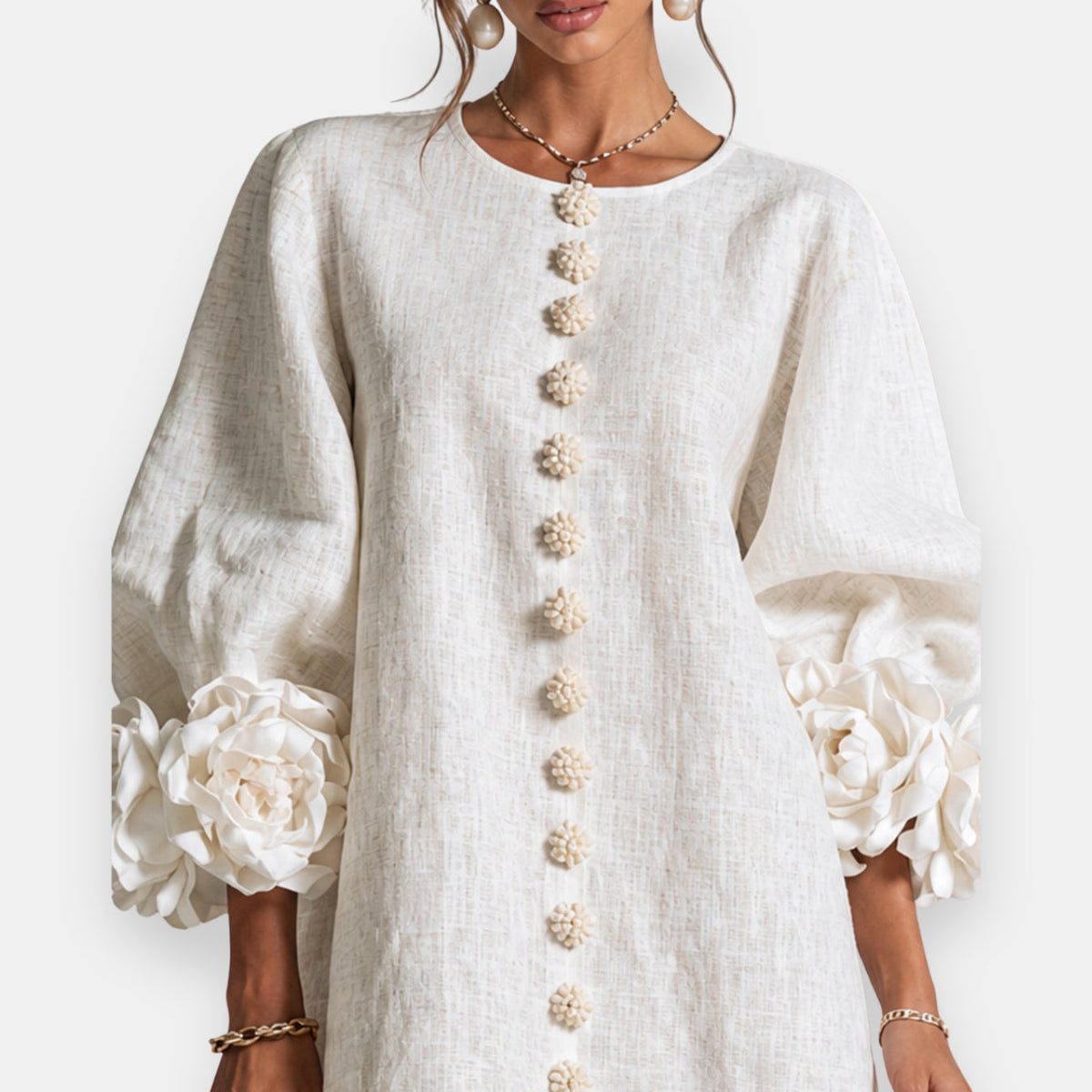 Rosamund Rosette Sleeve Shift Dress in Ivory – close-up of rosette cuffs and flower buttons