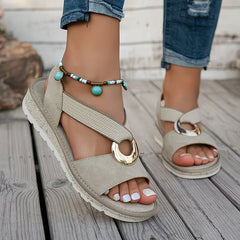 Tilda wedge sandals in Beige worn on foot, front angle