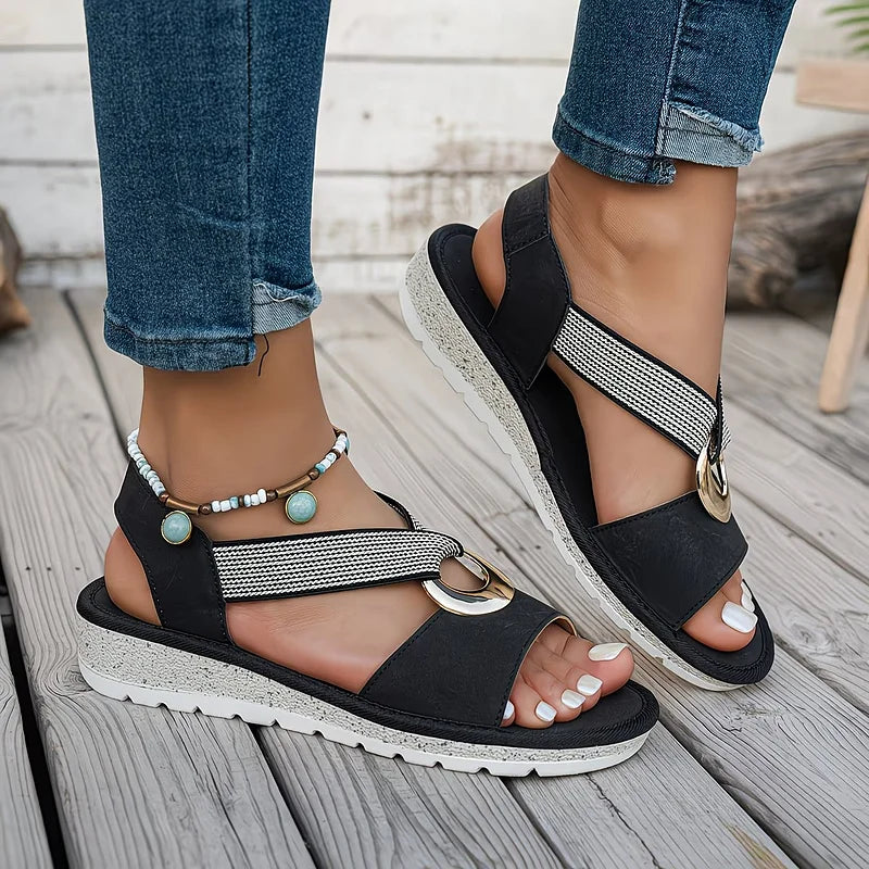 Tilda wedge sandals in Black worn on foot, side view