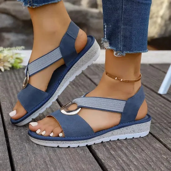 Tilda wedge sandals in Blue worn on foot, side view showing the low wedge