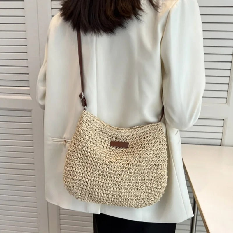 Petra woven crossbody bag in beige worn crossbody